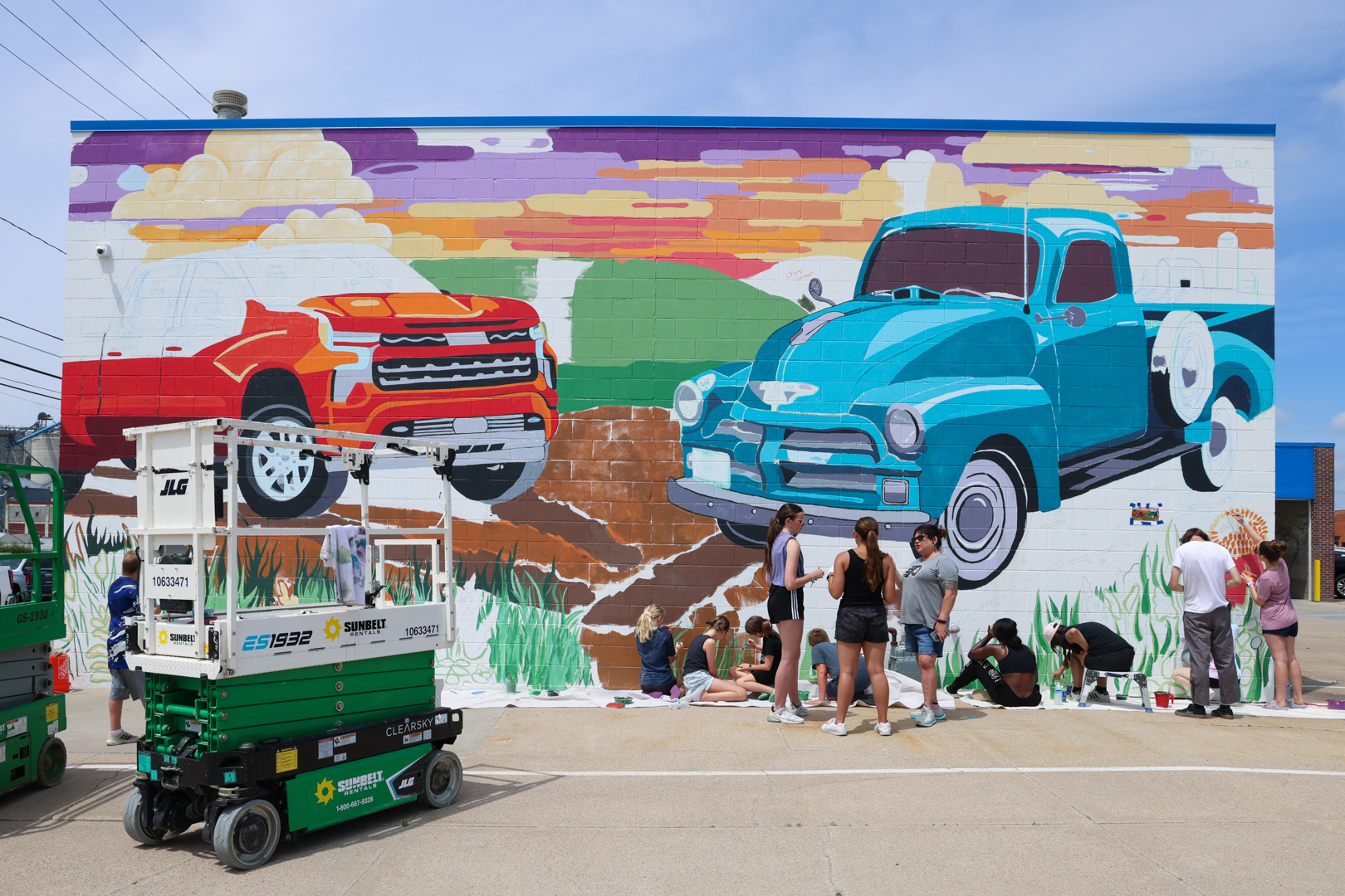 Members of the community join the "community paint day" in Beatrice to work on the city's newest mural designed by UNL student Maddie Vanderbur.