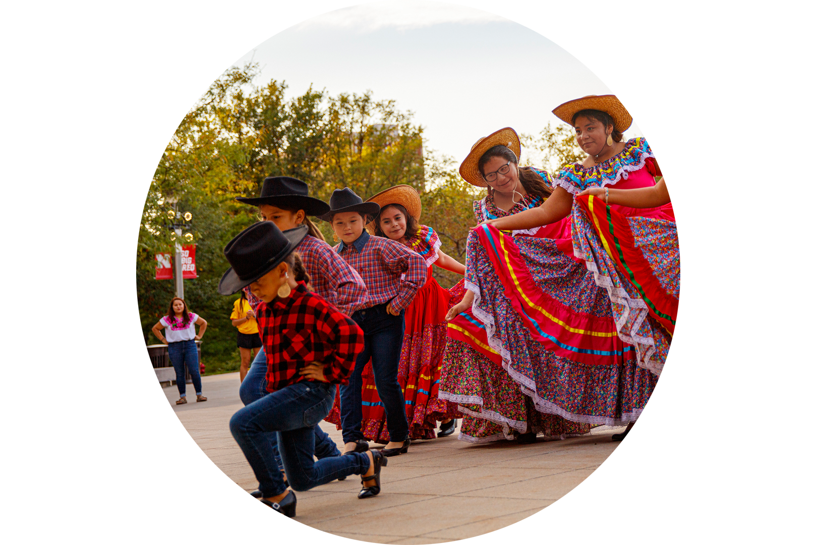 Women and children do a traditional latin dance.