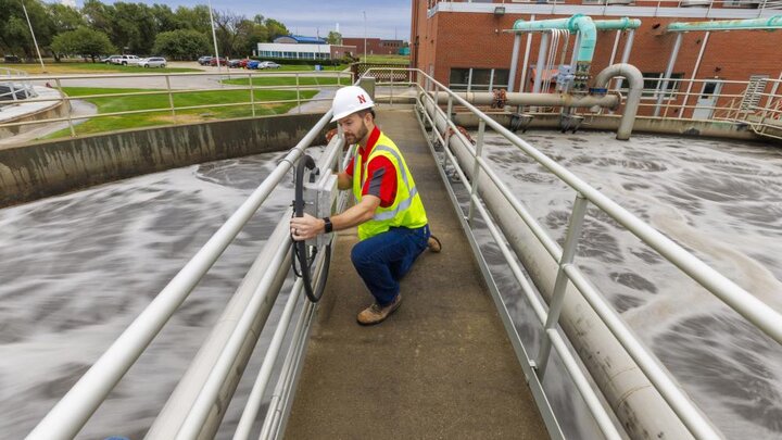 Andrew Hansen, graduate student in Environmental Engineering, looks over a control box for a sedimentation tank. Bruce Dvorak, Professor of Civil and Environmental Engineering, works with students at Lincoln’s Wastewater Treatment Plant northeast of Innovation Campus. September 23, 2022. Photo by Craig Chandler
