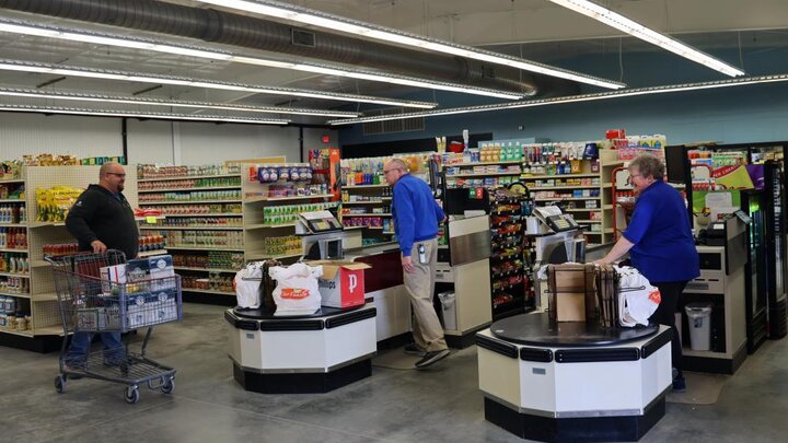 A customer makes a purchase at the Centennial Market Cooperative in Utica.