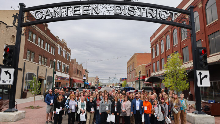 Participants at the 2025 CEC Conference gather for a photo op in North Platte’s Canteen District on Day 1 of the conference.”