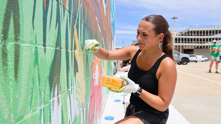 Maddie Vanderbur works on the mural in Beatrice that she designed as part of a street art class at the University of Nebraska–Lincoln.