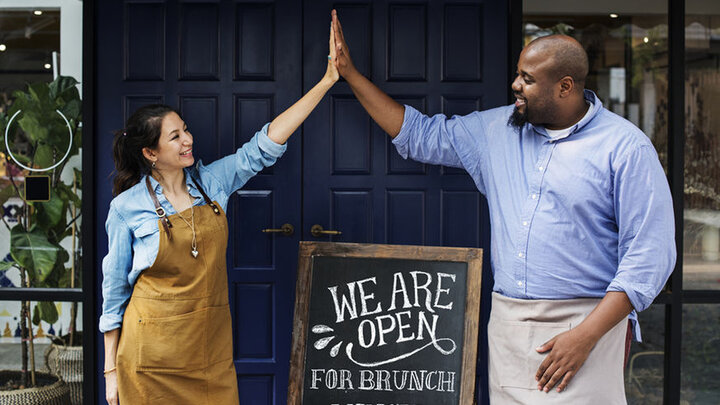 Stock photo of business owners celebrating.