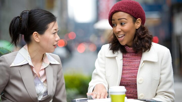 Stock photo of Two Business Women Having A Casual Meeting Or Discussion In The City.