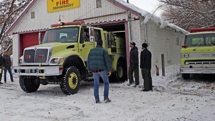 Volunteer fire fighters at a communtiy firehouse. Photographer unknown