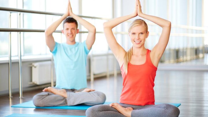 Stock photo of young couple practicing yoga.