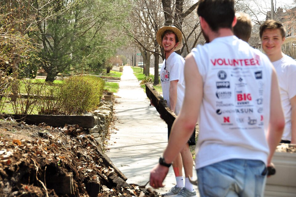 Young men volunteer to help clean up a community.