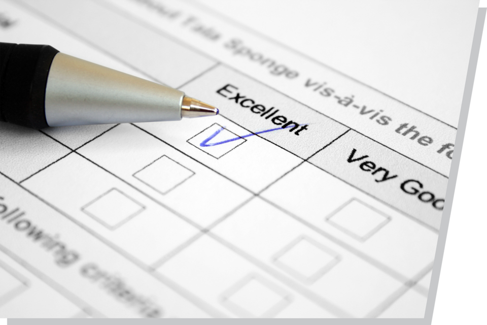 A pen checking an "Excellent" box on a survey paper.
